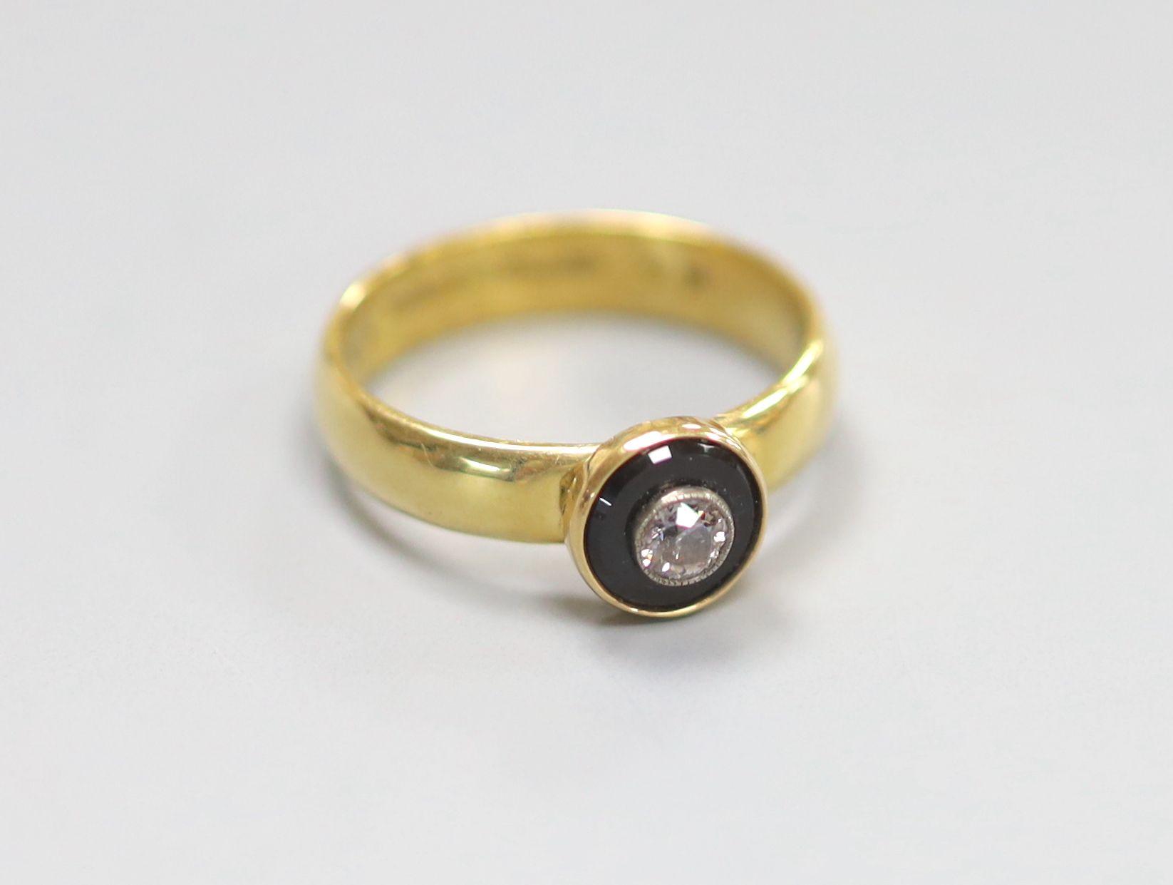 A modern 19th century style 18ct gold, black onyx and diamond set target ring